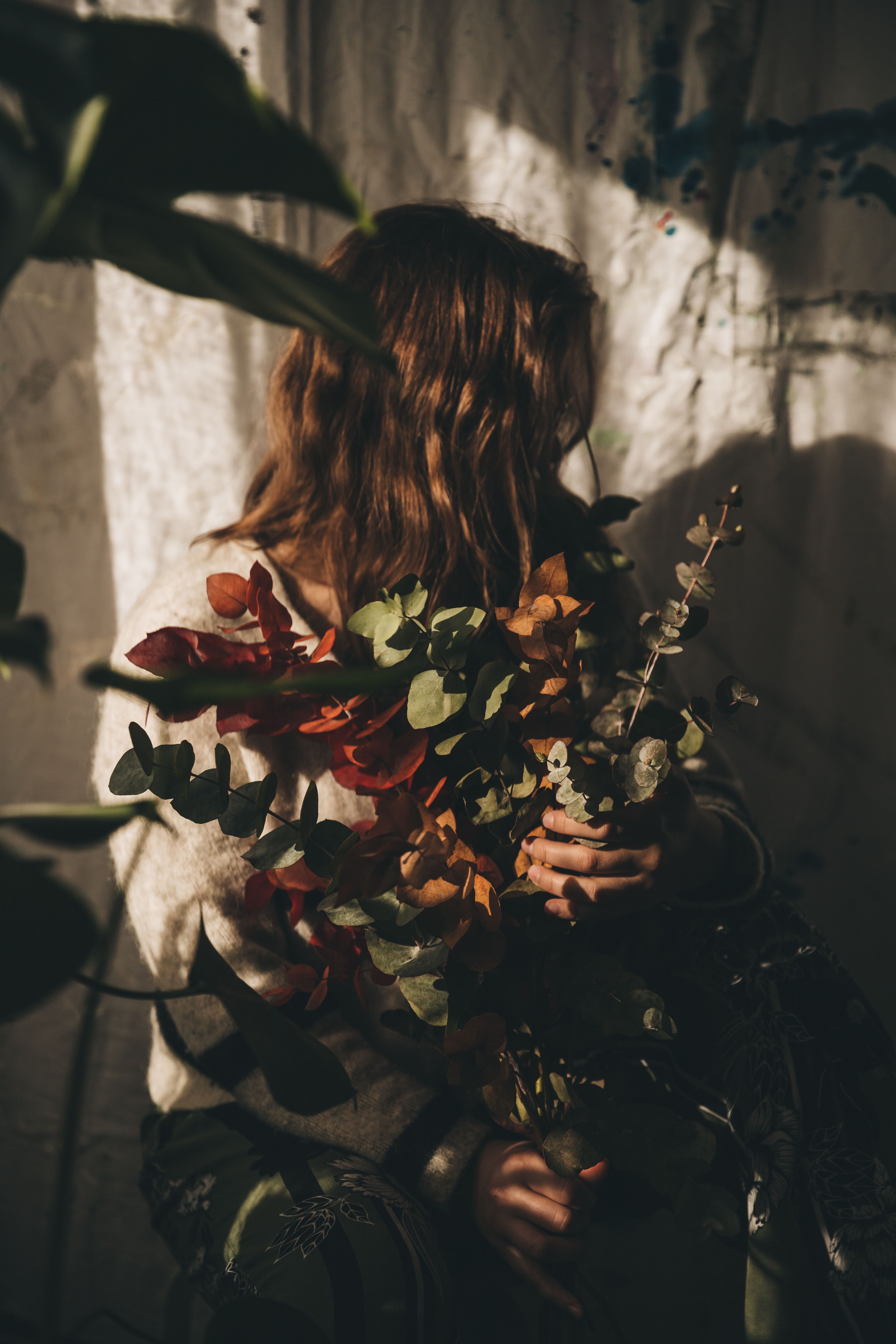 Rosalie working in her dark, mysterious florist conservatory studio